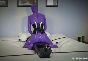 Sweet latex doll in a black corset is enjoying her lover